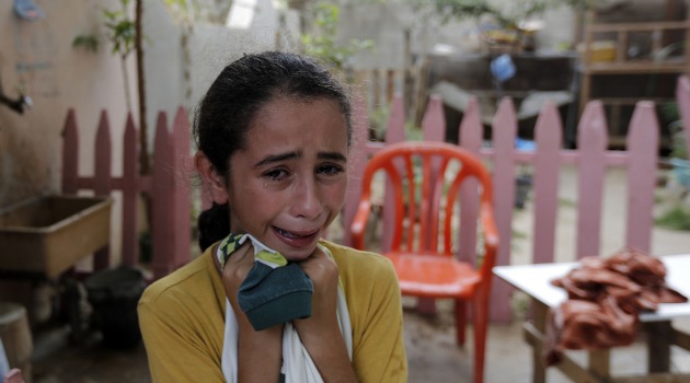 Sister weeps after hearing of the death of a Palestinian paramedic killed in Israeli attack on Shejaia neighborhood in Gaza.